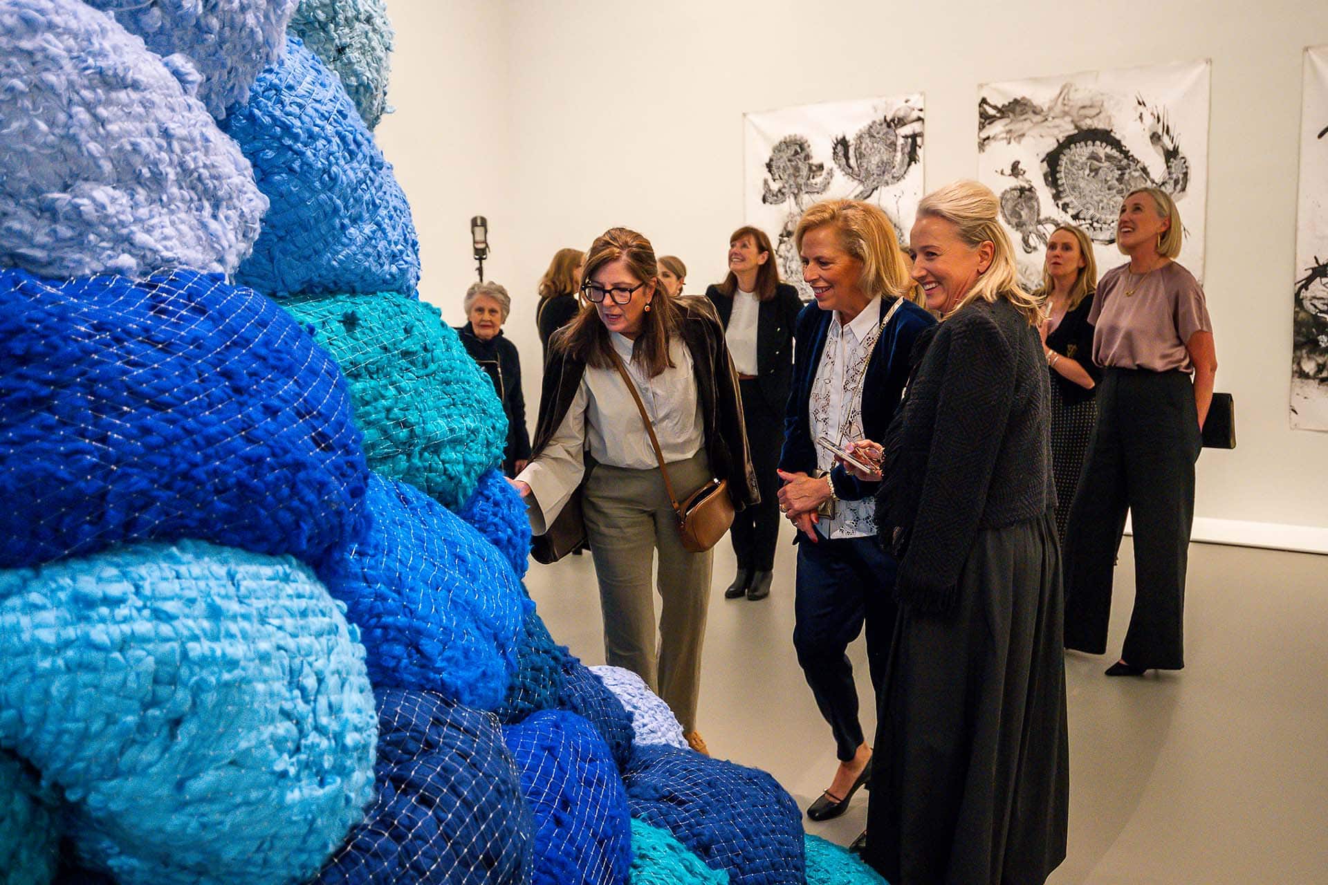 NGVWA Members viewing <em>Nowhere to go</em> by Sheila Hicks, 2022. Purchased with funds donated by the NGVWA. Image by Carmen Zammit
